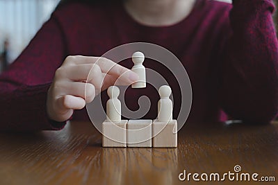 Hand Choose figure standing out from the group of crowd. Business hiring and recruitment selection. Stock Photo