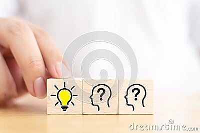 Hand choose wooden cube block with head human symbol and light bulb icon Stock Photo