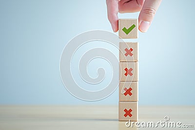 Hand choosing Green correct check mark among many red wrong or cross icon for true or false changing mindset. Stock Photo