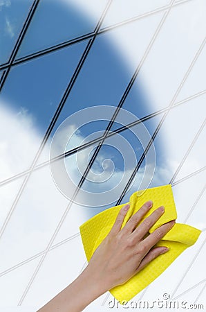 Hand cleaning a glass surface of a building Stock Photo