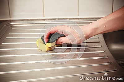 Hand cleaning kitchen sink Stock Photo