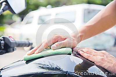 Hand with cleaning motorcycle Stock Photo