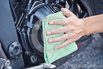 Hand with cleaning motorcycle Stock Photo