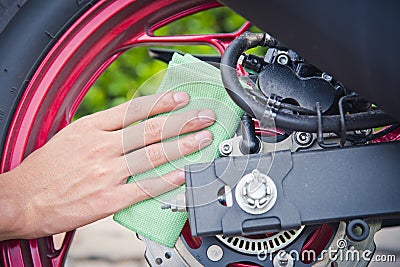 Hand with cleaning motorcycle Stock Photo