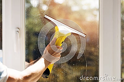 Hand cleaning window with vacuum cleaner Stock Photo