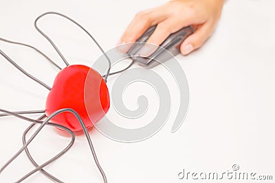 Hand click on the computer mouse to check, open, discover or unlock what is inside the heart. Healthcare checkup or finding heart Stock Photo
