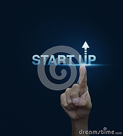 Hand click on start up icon over blue background, Start up business concept Stock Photo