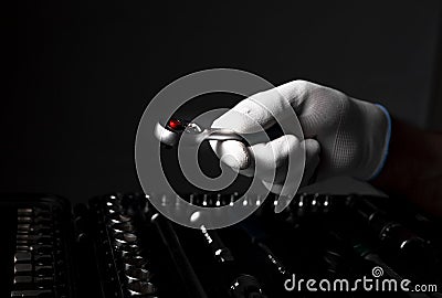 Hand close up in white glove with metal steel socket ratchet handle over toolkit Stock Photo