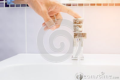 Hand close water tap Stock Photo