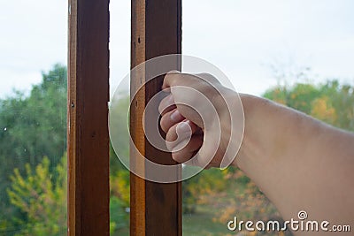 Hand closing the window Stock Photo