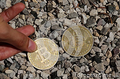 hand collects coins with capital b Symbolizing Bitcoin cryptocur Stock Photo