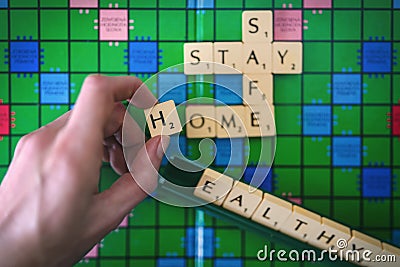 Words forming with Scrabble game letters - stay, safe, home, healthy. Editorial Stock Photo