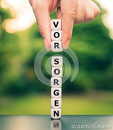 Hand compliments three dice and changes the German word Stock Photo