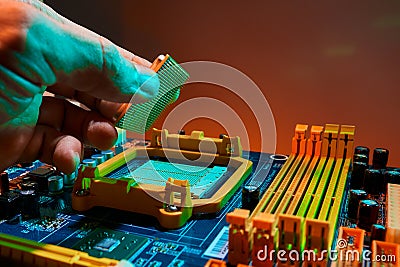 Hand of computer engineer replace computer cpu change components into socket processor for maintenance Stock Photo