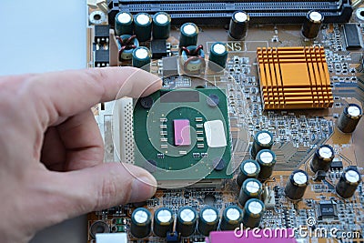 Hand of computer engineering plugging computer cpu processor memory change components into socket processor. Computer technology Stock Photo
