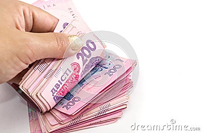 Hand counts hryvnia in money stack on a white background. Close-up.Copy space. Stock Photo