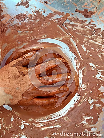 A hand covered in clay Stock Photo