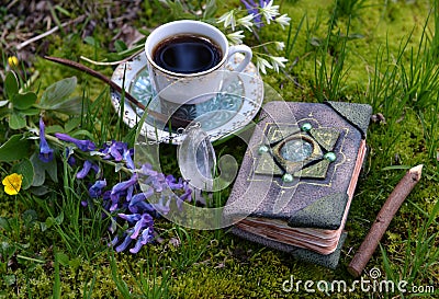 Hand crafted diary book with flowers, crystal and tea cup in the garden. Stock Photo