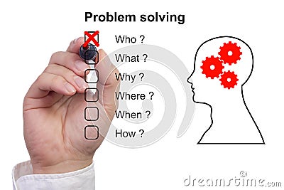 Hand crosses off first item of a problem solving checklist Stock Photo