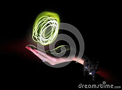 Hand cupping a ball of light Stock Photo