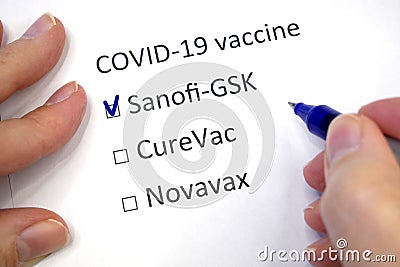 Hand daw in the questionnaire. Choice of vaccine: Sanofi-GSK, CureVac, Novavax. A closeup of female hand answering about a covid- Editorial Stock Photo