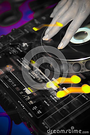 Hand of a DJ on a turntable in a nightclub Stock Photo