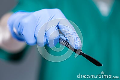Hand of doctor holding scalpel Stock Photo