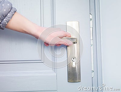 Hand and the door handle Stock Photo