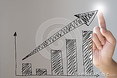 Hand drawing bar chart and rising arrow for economic business growth. Stock Photo