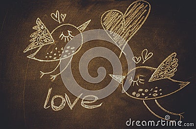 Hand drawing with chalk on blackboard, cute kawaii birds, heart and word love, St.ValentineÂ´s Stock Photo