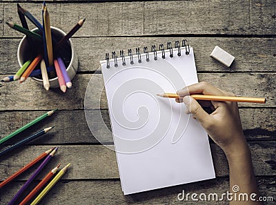 Hand drawing, sketch paper and colorful pencils on old wooden ba Stock Photo