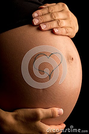 Hand-drawn heart on the belly of a pregnant woman Stock Photo