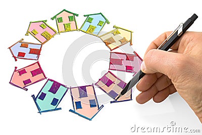 Hand draws many houses on circle with a pencil on a sheet Stock Photo