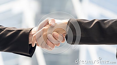 Hand in dressed strictly in the suits shake together Stock Photo