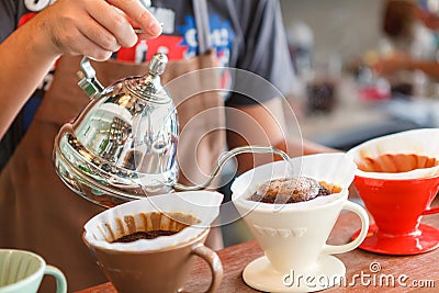 Hand drip coffee, Barista pouring water on coffee ground with filter Stock Photo