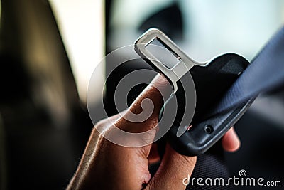 Hand of driver holding seat belt safety belt lock in car. Stock Photo