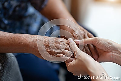 Hand of elderly woman holding hand younger woman, Helping hands, take care for the elderly concept Stock Photo