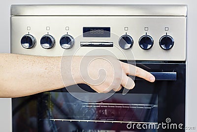 Hand on electric cooker Stock Photo