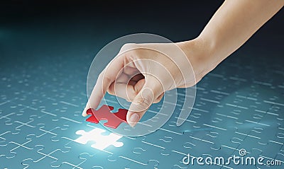 Hand embed missing puzzle piece into place. Stock Photo