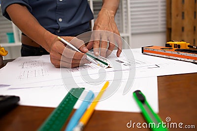 Hand engineers are writing home construction designs to bring them to prospective customers Stock Photo