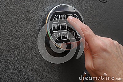 Hand opening digital lock on safe Stock Photo