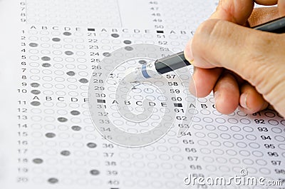 Hand erase wrong answer on Exam . Stock Photo