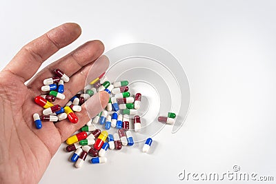 Hand falling down with pills. Pass out, suicide, overdose, sick, faint. Stock Photo