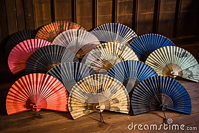 hand fans arranged in a circle on a rustic wooden table Stock Photo