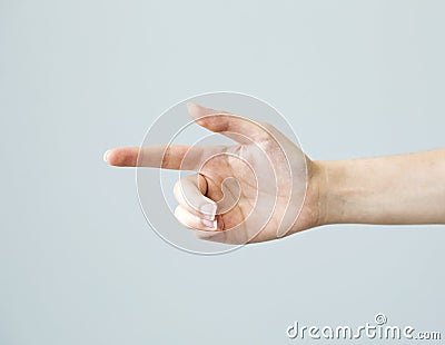 Hand finger pointing on grey background Stock Photo