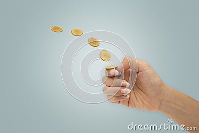 Hand is flipping a coin isolated on blue background Stock Photo