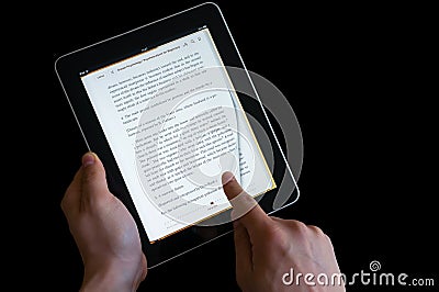 Hand flipping page on an ipad screen Editorial Stock Photo