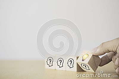Hand flipping wooden cube block which print screen face with questions mark to lightbulb, creative idea and innovation concept Stock Photo