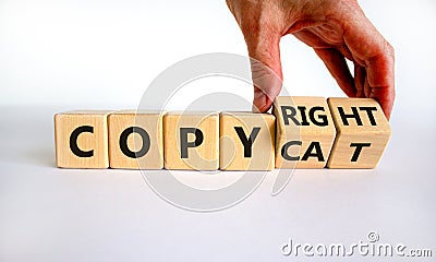 Hand flips cubes and changes the word `copycat` to `copyright`. Beautiful white background. Business concept. Copy space Stock Photo