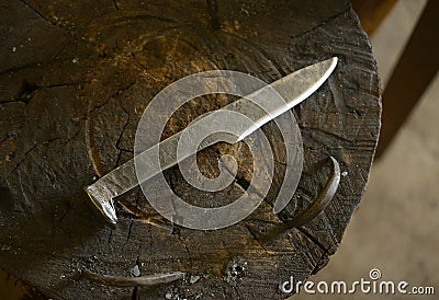 Hand Forged Steel Knife on Anvil Stock Photo